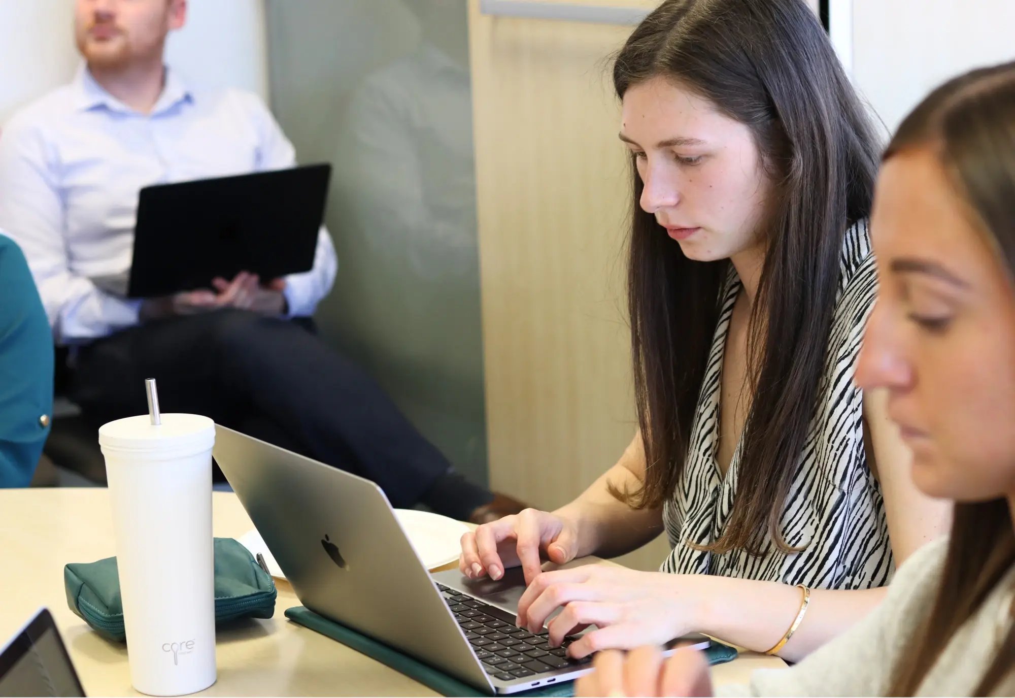Team on laptops in meeting